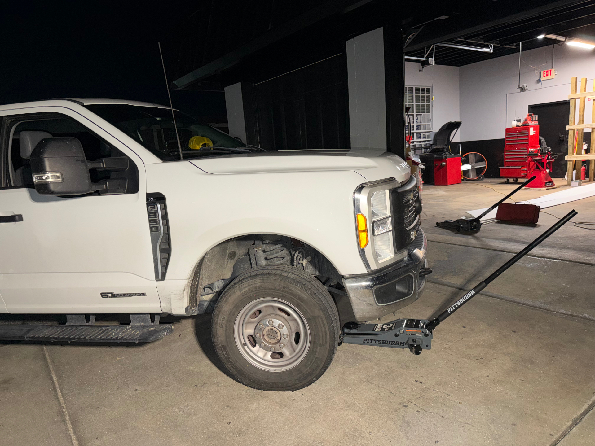 Truck lifted for tire service in the Poveda's bay